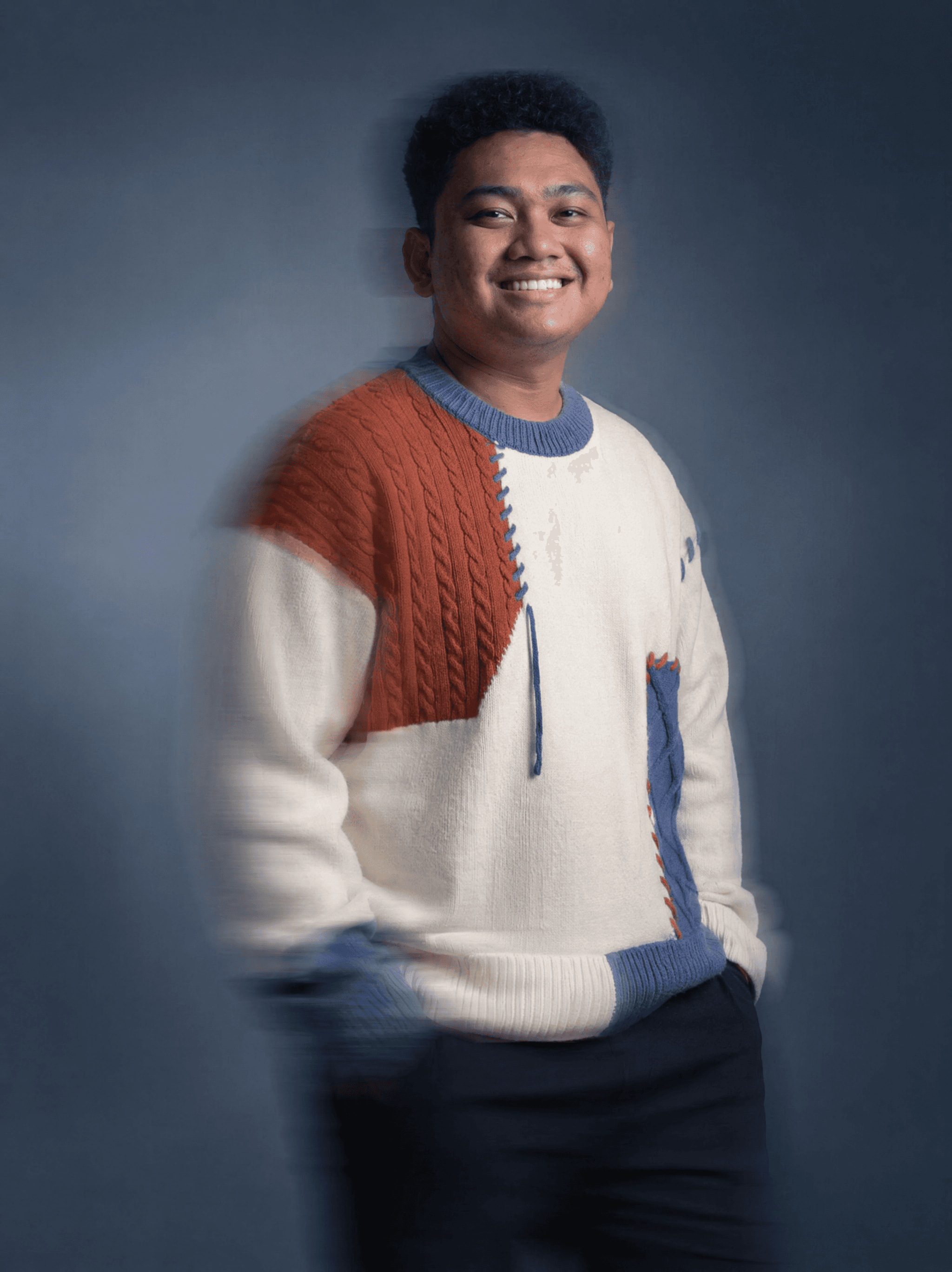 Ikhsan Naim smiling, studio portrait with motion-blur effect